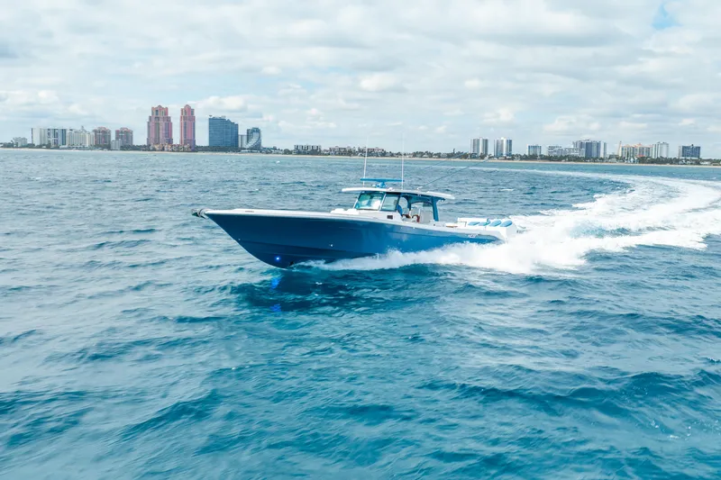 Slide: The Image of 2026 HCB 53 Suenos RXV cruising on open water near city skyline. - 48