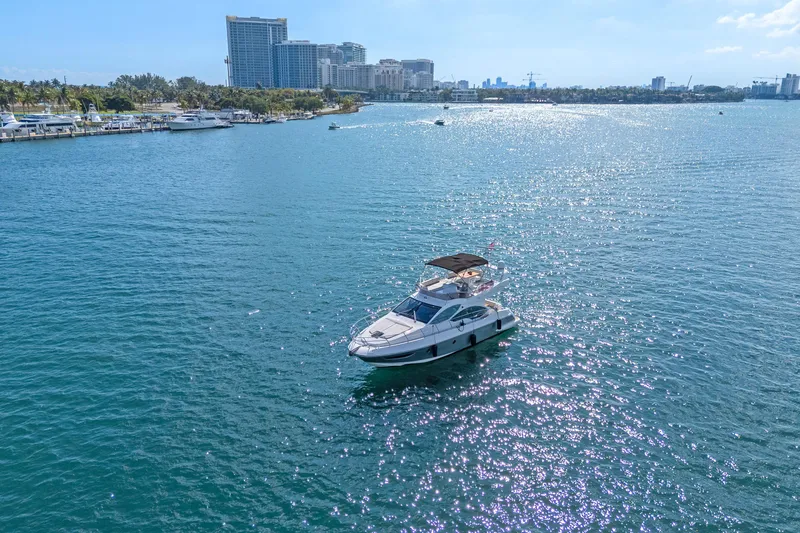 Slide: The Image of Azimut 45 Flybridge 2013 yacht cruising on a sunny day near city skyline. - 10