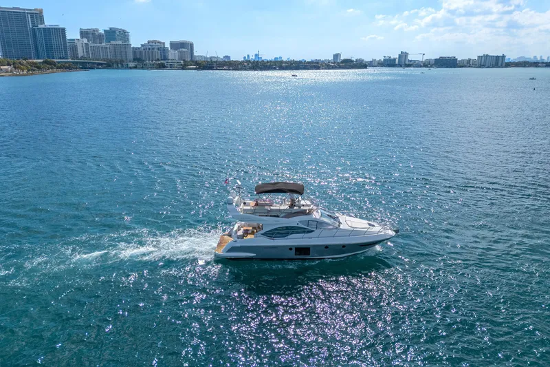 Slide: The Image of 2013 Azimut 45 Flybridge yacht cruising on a sunny day near city skyline. - 12
