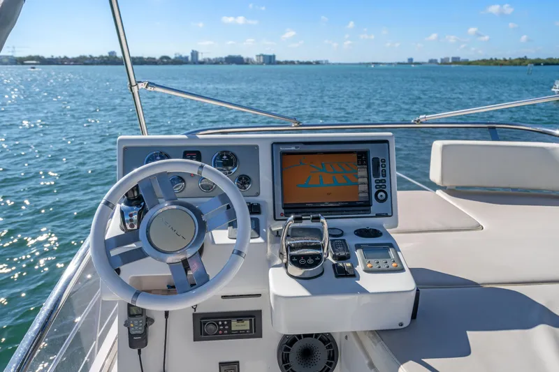 Slide: The Image of 2013 Azimut 45 Flybridge yacht helm with navigation system on open water. - 15