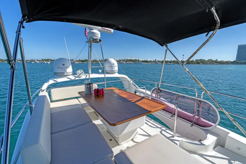 Slide: The Image of 2013 Azimut 45 Flybridge yacht with spacious deck, table, and ocean view. - 17