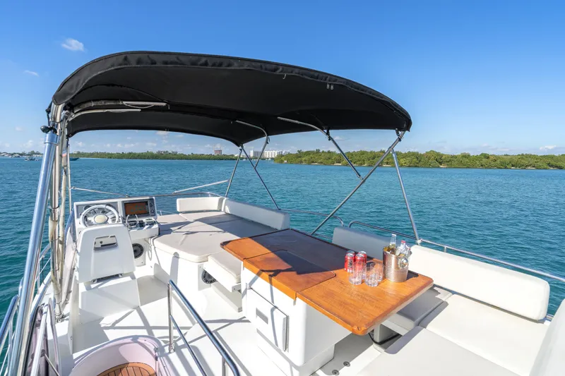 Slide: The Image of 2013 Azimut 45 Flybridge yacht with shaded seating area and ocean view. - 21
