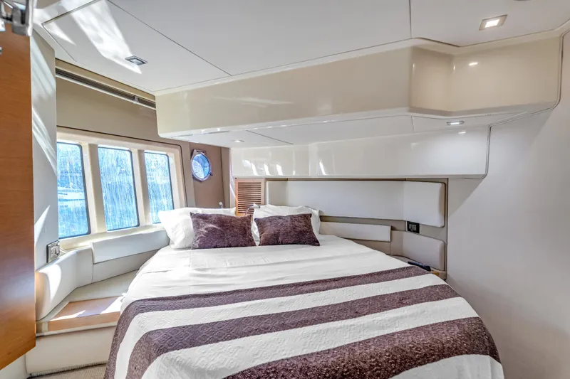 Slide: The Image of Luxurious bedroom interior of 2013 Azimut 45 Flybridge yacht with large windows and cozy bedding. - 22