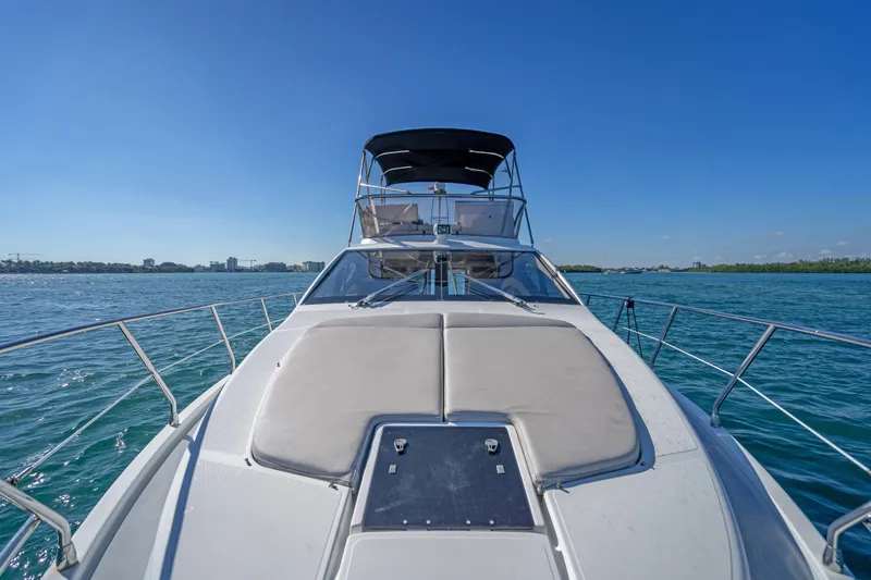 Slide: The Image of 2013 Azimut 45 Flybridge yacht cruising on clear blue waters under a sunny sky. - 6