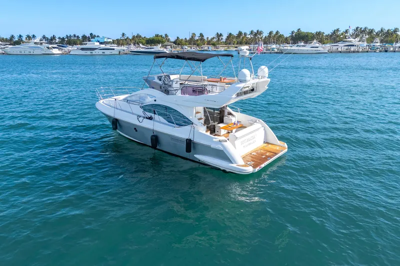 Slide: The Image of 2013 Azimut 45 Flybridge yacht on blue water, with marina in background. - 9