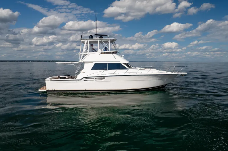 Slide: The Image of 2000 Tiara Yachts 4300 Convertible on calm water under a partly cloudy sky. - 20