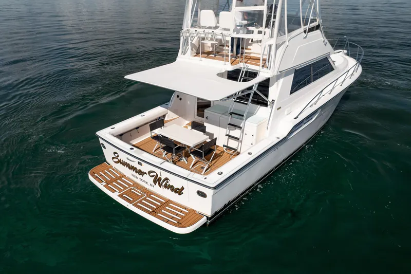 Slide: The Image of 2000 Tiara Yachts 4300 Convertible on water, rear view with deck and seating. - 39