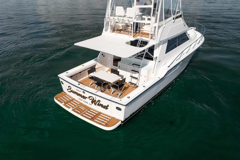 Slide: The Image of 2000 Tiara Yachts 4300 Convertible on water, featuring spacious deck and elegant design. - 40