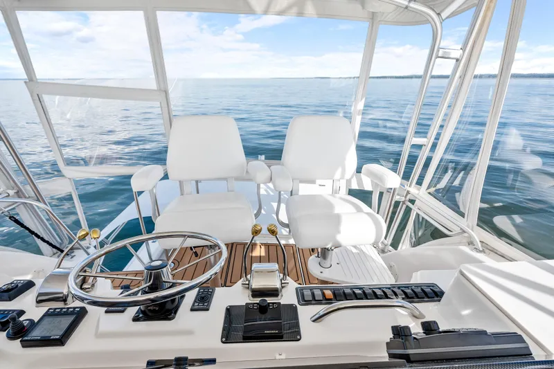 Slide: The Image of Helm of 2000 Tiara Yachts 4300 Convertible with ocean view and modern controls. - 45