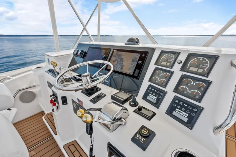 Slide: The Image of Cockpit of 2000 Tiara Yachts 4300 Convertible with navigation screens and controls. - 46