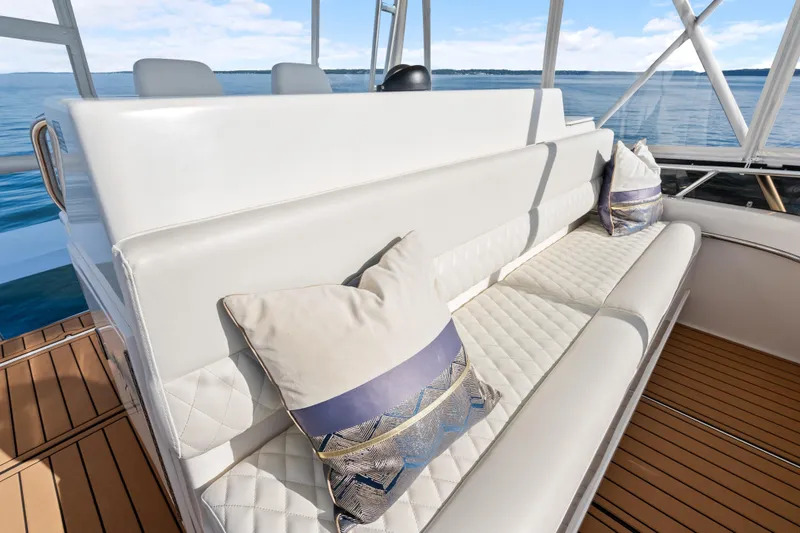 Slide: The Image of Luxurious seating on 2000 Tiara Yachts 4300 Convertible, featuring elegant cushions and scenic ocean view. - 48