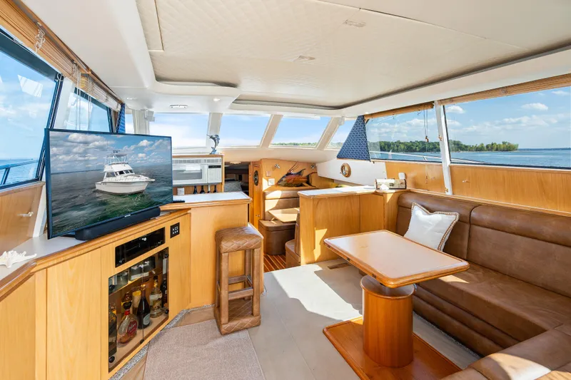 Slide: The Image of Luxurious interior of 2000 Tiara Yachts 4300 Convertible with leather seating and scenic views. - 49