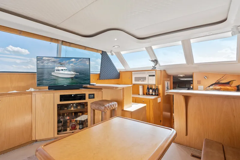 Slide: The Image of Interior of 2000 Tiara Yachts 4300 Convertible with TV, bar, and skylights. - 50