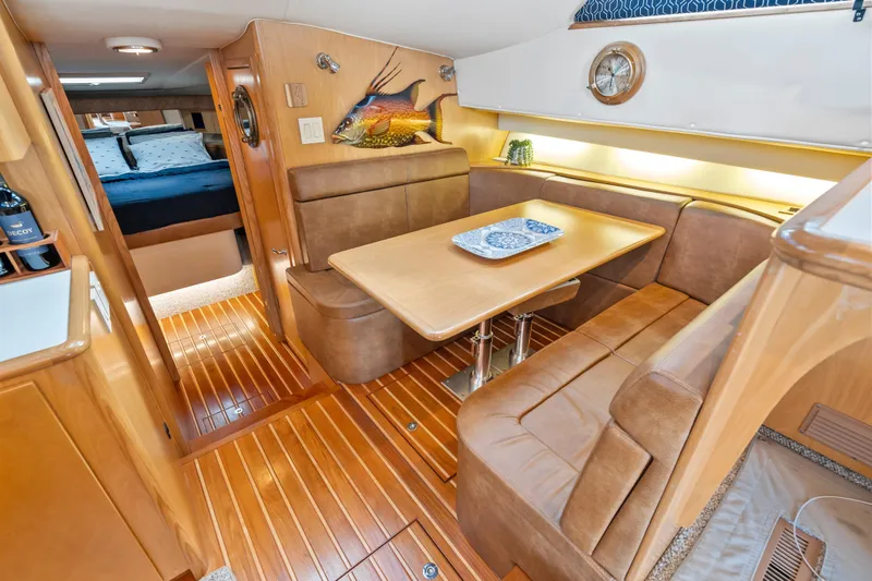 Slide: The Image of Luxurious interior of 2000 Tiara Yachts 4300 Convertible with elegant dining area and wood finishes. - 54