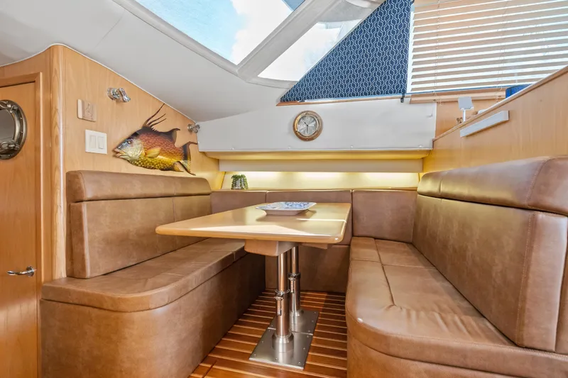 Slide: The Image of Luxurious interior of 2000 Tiara Yachts 4300 Convertible with leather seating and wooden accents. - 55