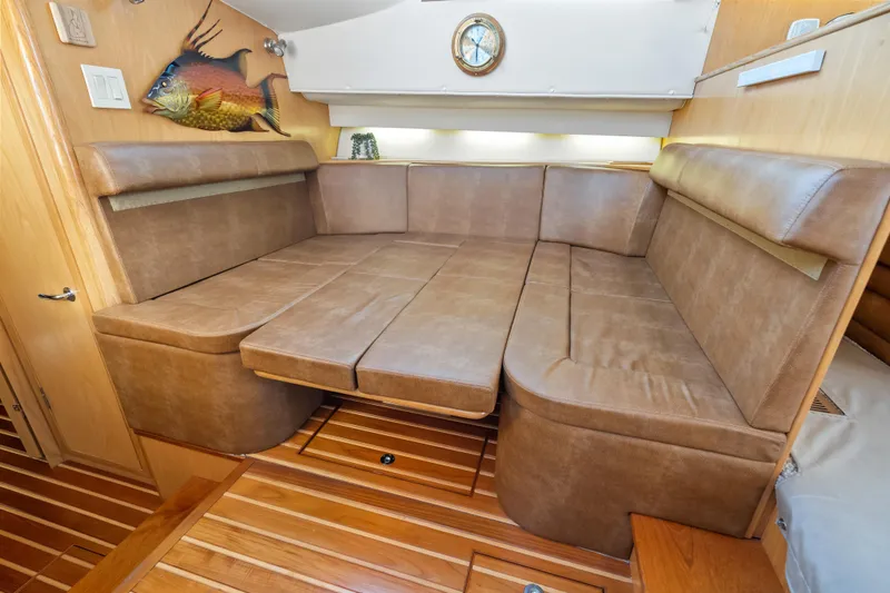 Slide: The Image of Luxurious interior of 2000 Tiara Yachts 4300 Convertible with leather seating and wooden flooring. - 56