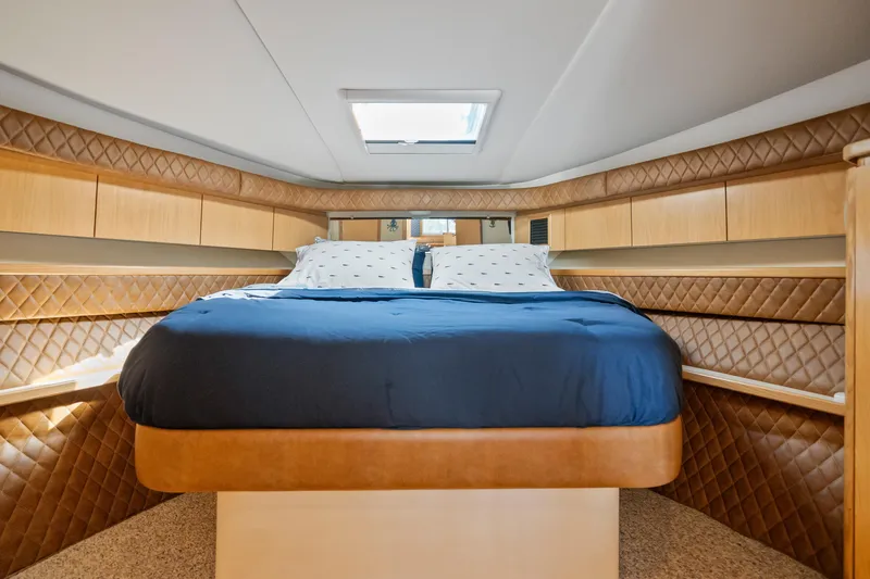 Slide: The Image of Luxurious bedroom interior of 2000 Tiara Yachts 4300 Convertible with quilted walls and skylight. - 60