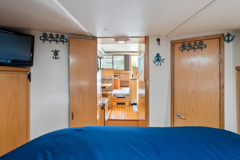 Slide: The Image of Interior of 2000 Tiara Yachts 4300 Convertible, featuring wood accents and nautical decor. - 61