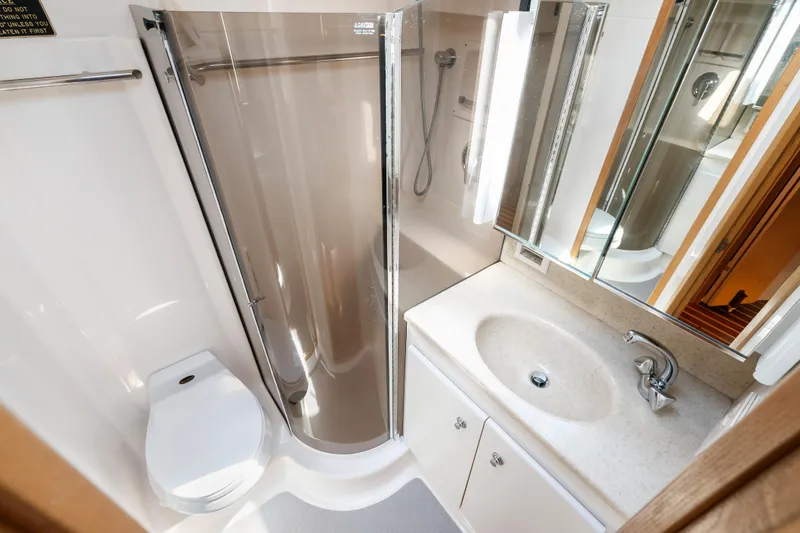 Slide: The Image of Luxurious bathroom in 2000 Tiara Yachts 4300 Convertible with shower, sink, and toilet. - 62