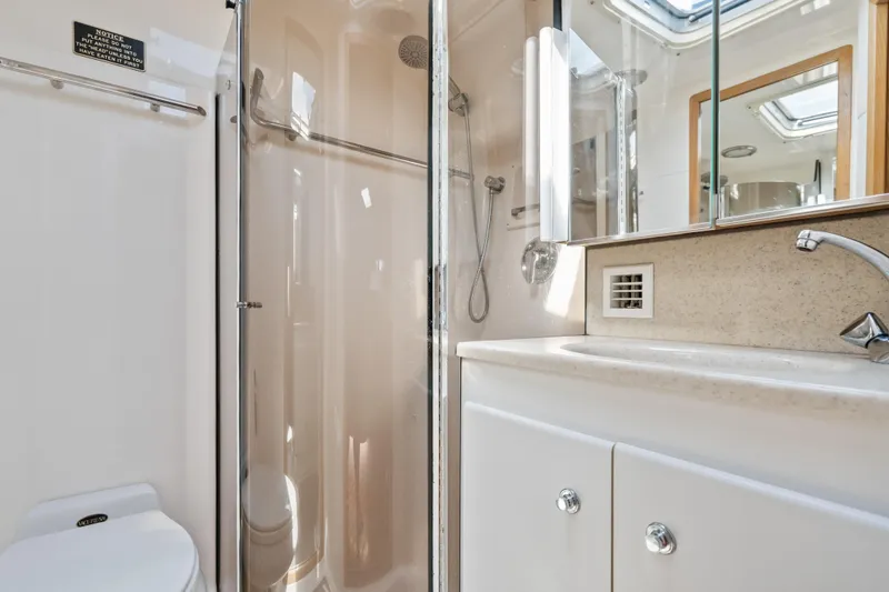 Slide: The Image of Luxurious bathroom in 2000 Tiara Yachts 4300 Convertible, featuring shower and vanity. - 63
