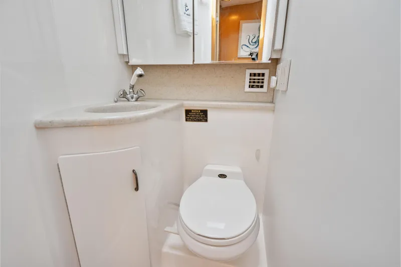 Slide: The Image of Compact yacht bathroom with sink and toilet, Tiara Yachts 4300 Convertible, 2000 model. - 64