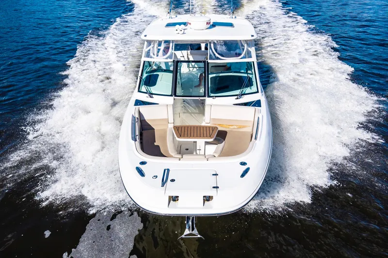 Slide: The Image of 2019 Boston Whaler 320 Vantage cruising on open water, aerial view. - 10