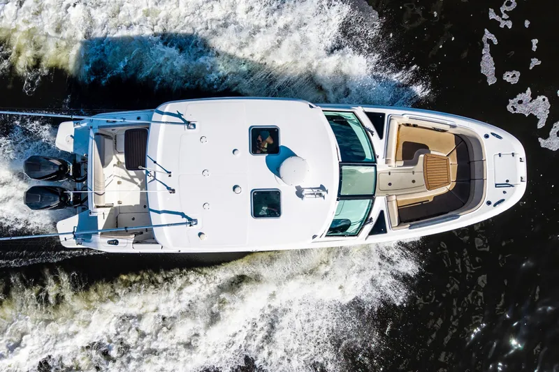 Slide: The Image of Aerial view of 2019 Boston Whaler 320 Vantage cruising on water. - 11
