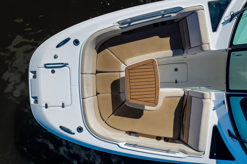 Slide: The Image of 2019 Boston Whaler 320 Vantage boat interior with tan seating and wooden accents. - 15