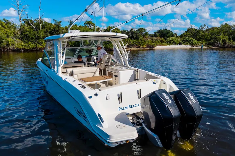 Slide: The Image of 2019 Boston Whaler 320 Vantage boat on water, featuring dual Mercury engines. - 16