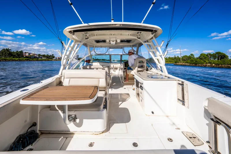 Slide: The Image of 2019 Boston Whaler 320 Vantage boat interior with seating and table on a sunny day. - 20