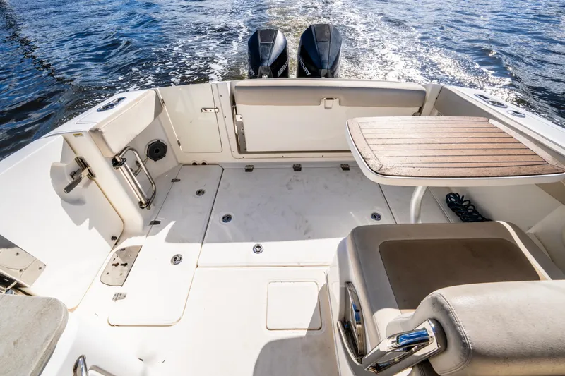Slide: The Image of 2019 Boston Whaler 320 Vantage boat interior with seating and table on water. - 22