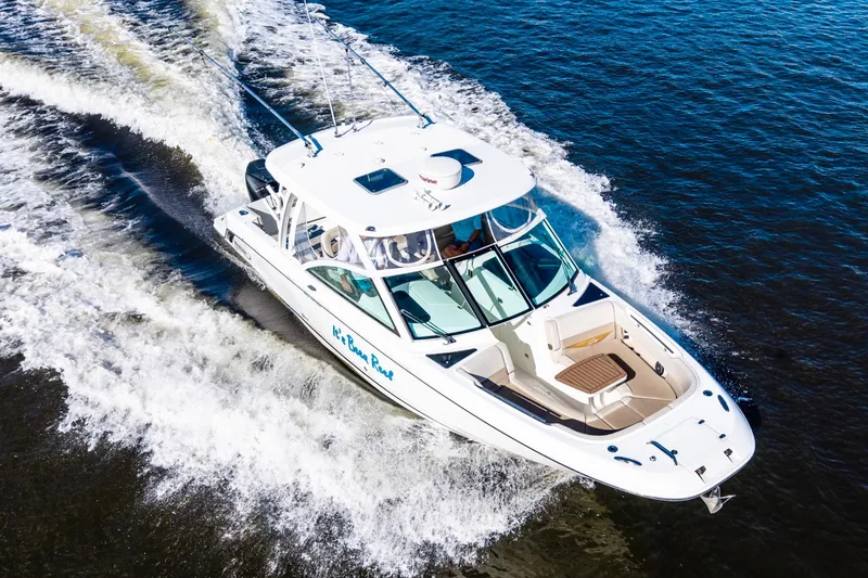 Slide: The Image of 2019 Boston Whaler 320 Vantage cruising on open water, aerial view. - 4