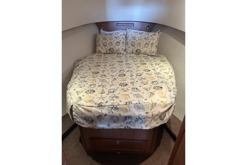 Slide: The Image of Cozy bedroom in 2008 Mainship 34 Trawler with seashell-patterned bedding. - 11