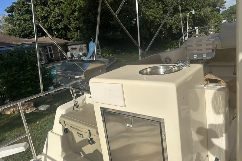 Slide: The Image of 2008 Mainship 34 Trawler outdoor kitchen area with sink and grill. - 22