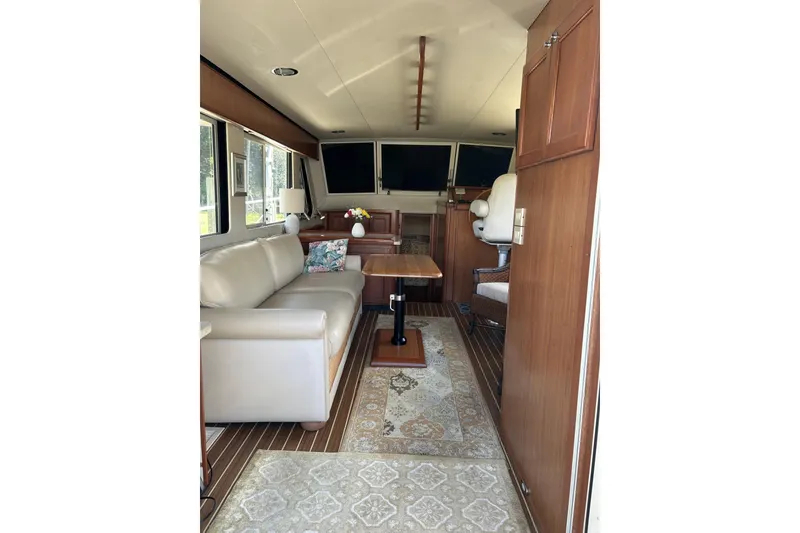 Slide: The Image of Interior of 2008 Mainship 34 Trawler with elegant seating and wooden finishes. - 3