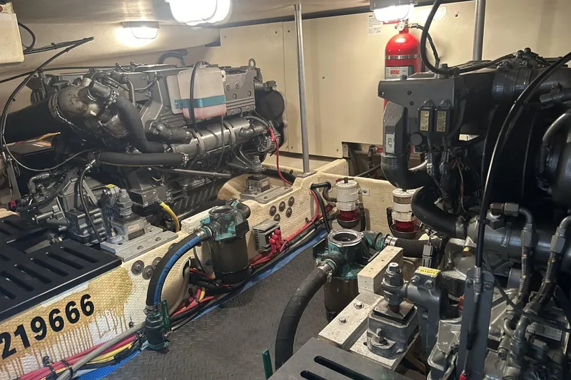 Slide: The Image of Engine room of a 2008 Mainship 34 Trawler, showcasing dual engines and mechanical components. - 30