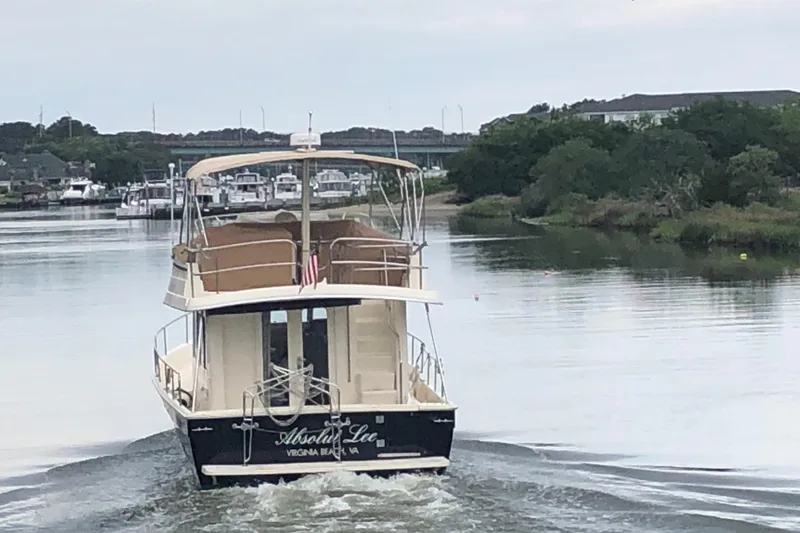 Slide: The Image of 2008 Mainship 34 Trawler cruising on a calm river near Virginia Beach. - 40