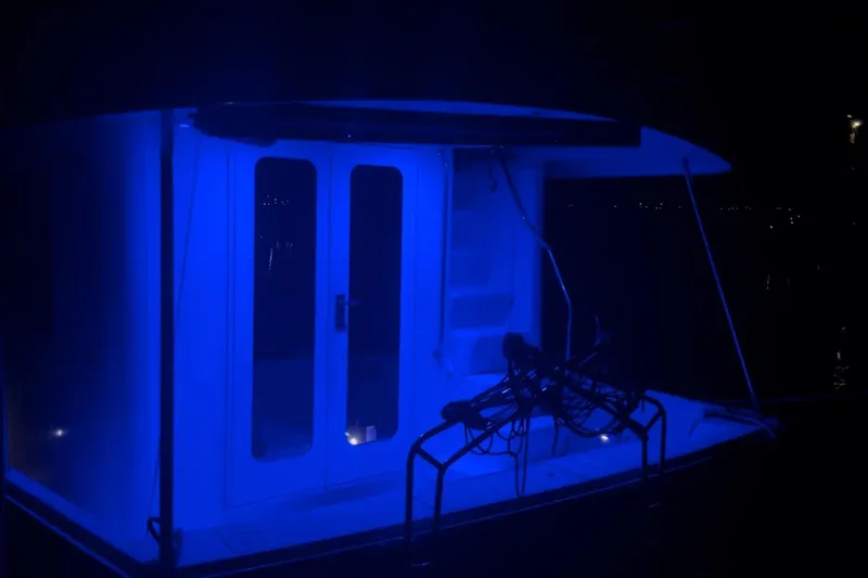 Slide: The Image of 2008 Mainship 34 Trawler illuminated in blue light at night. - 41