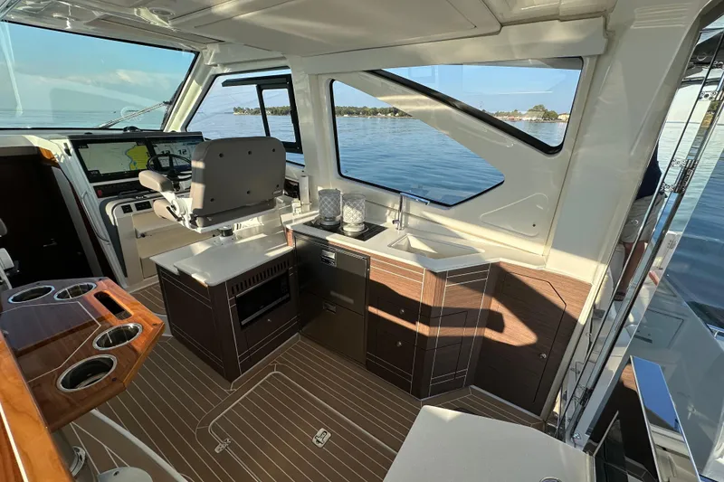 Slide: The Image of Luxurious interior of 2024 Pursuit OS 445 Offshore boat with modern helm and cabinetry. - 10