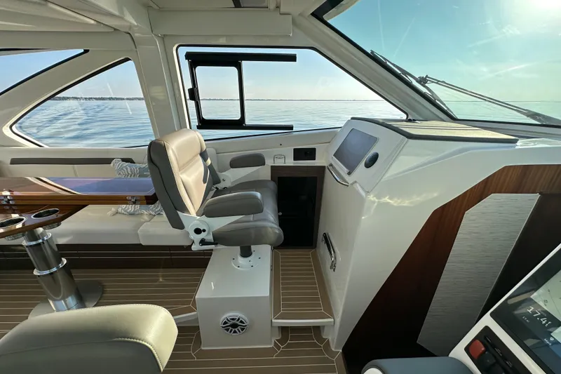 Slide: The Image of 2024 Pursuit OS 445 Offshore helm with luxurious seating and modern controls. - 11