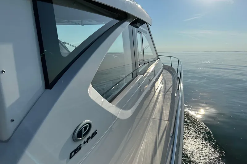 Slide: The Image of 2024 Pursuit OS 445 Offshore yacht cruising on calm waters under clear skies. - 12