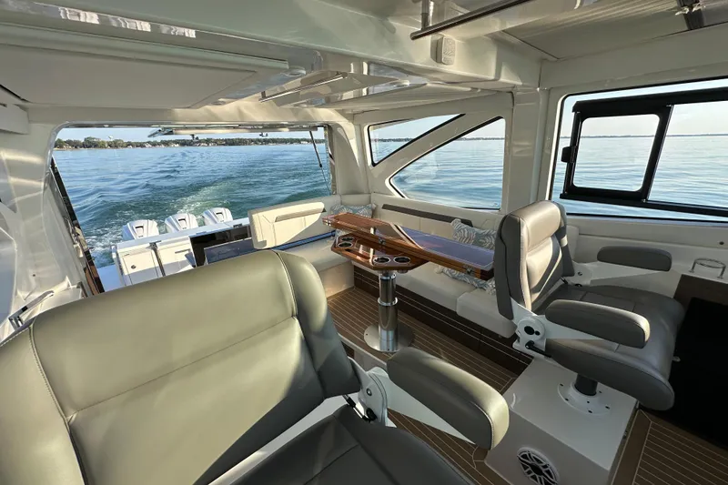 Slide: The Image of Luxurious interior of 2024 Pursuit OS 445 Offshore boat with leather seating and ocean view. - 13