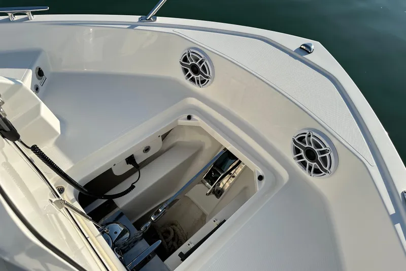 Slide: The Image of 2024 Pursuit OS 445 Offshore boat deck with storage compartment and speakers. - 16