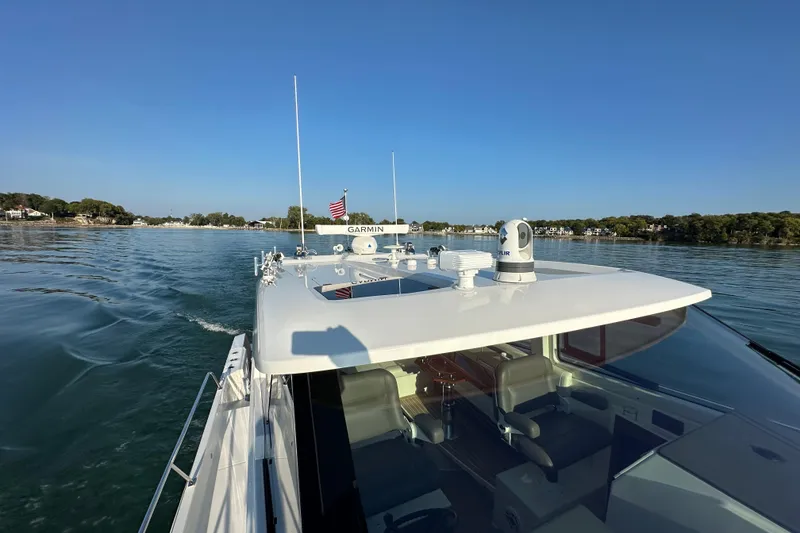 Slide: The Image of 2024 Pursuit OS 445 Offshore cruising on calm waters under clear blue sky. - 19