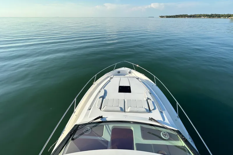 Slide: The Image of 2024 Pursuit OS 445 Offshore boat cruising on calm waters, scenic view. - 23