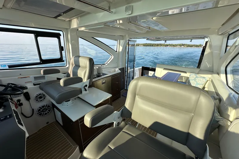 Slide: The Image of 2024 Pursuit OS 445 Offshore interior with luxurious seating and ocean view. - 30