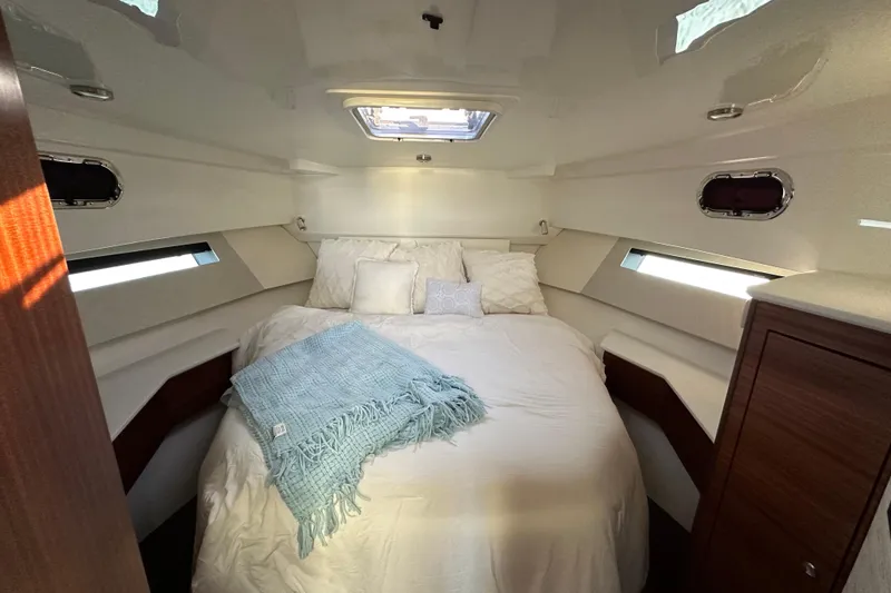 Slide: The Image of Luxurious cabin interior of 2024 Pursuit OS 445 Offshore yacht, featuring cozy bedding and elegant design. - 33