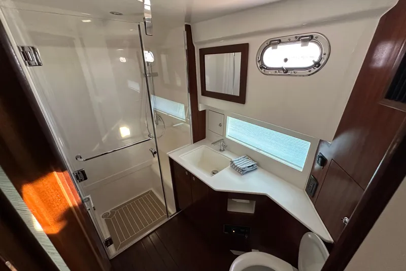 Slide: The Image of Luxurious bathroom in 2024 Pursuit OS 445 Offshore yacht with modern fixtures and elegant design. - 34