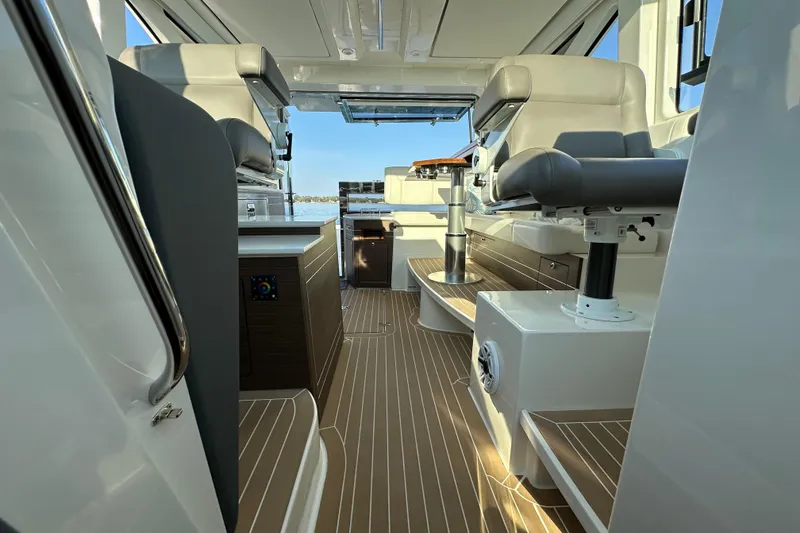 Slide: The Image of 2024 Pursuit OS 445 Offshore interior with modern seating and sleek design. - 37