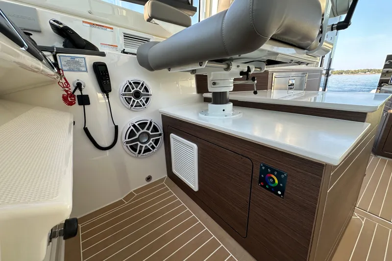 Slide: The Image of 2024 Pursuit OS 445 Offshore boat interior with modern controls and seating. - 38